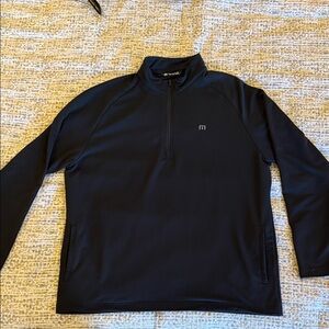 Black Travis Mathew quarter zip pullover.